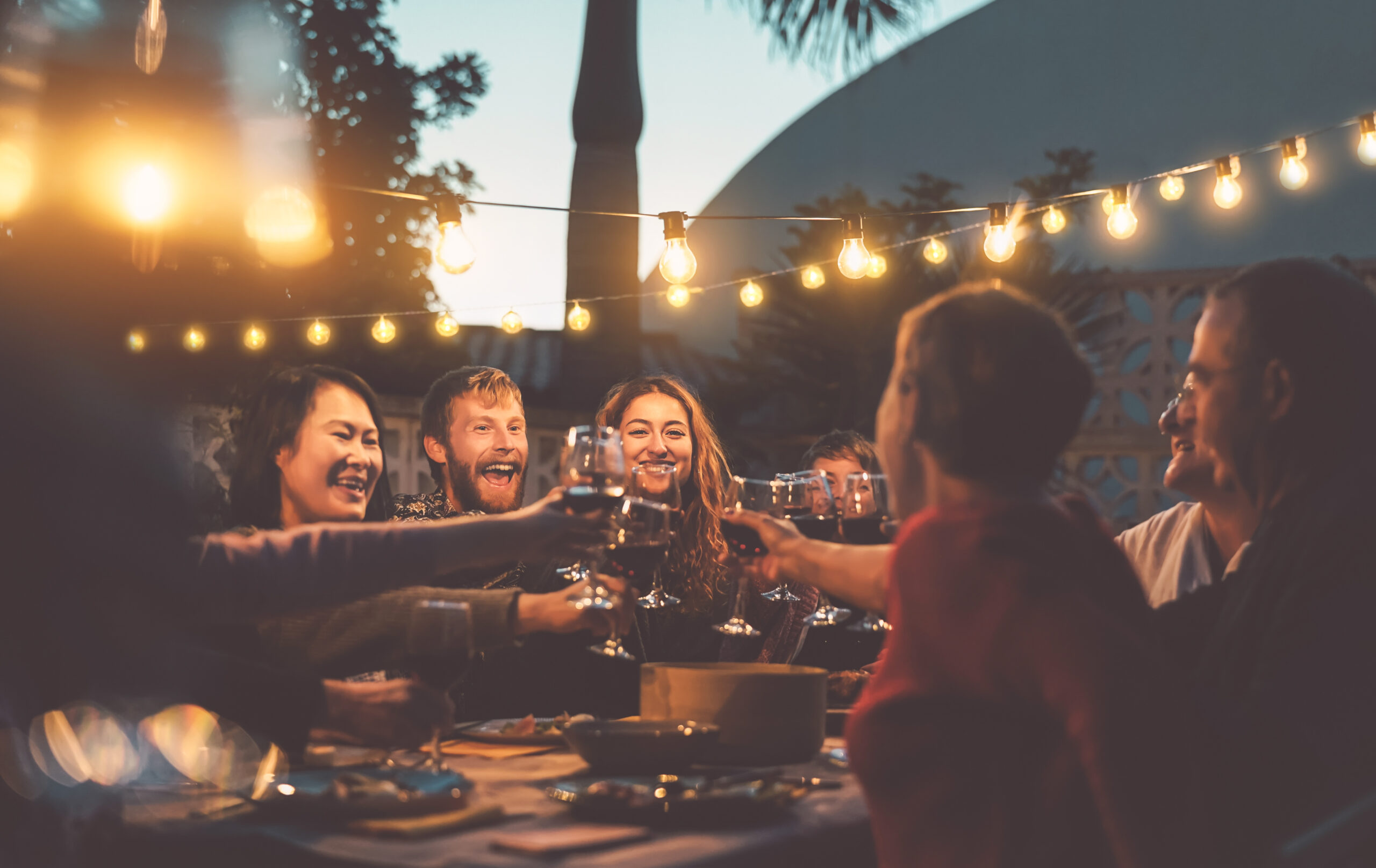 Happy family dining and tasting red wine glasses in barbecue din